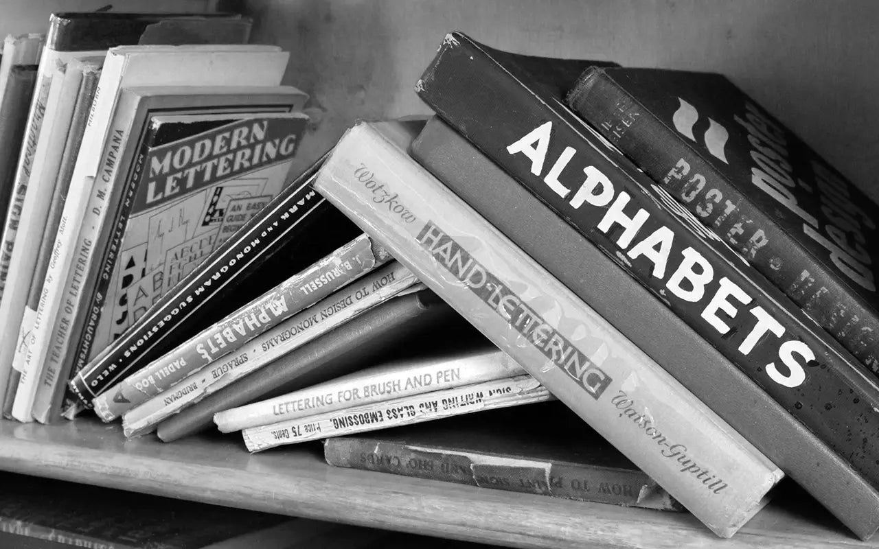 Stack of books on calligraphy and lettering with titles visible